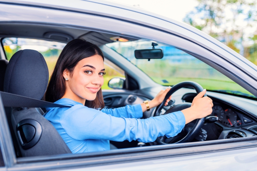 Woman Driving a Silver Car
