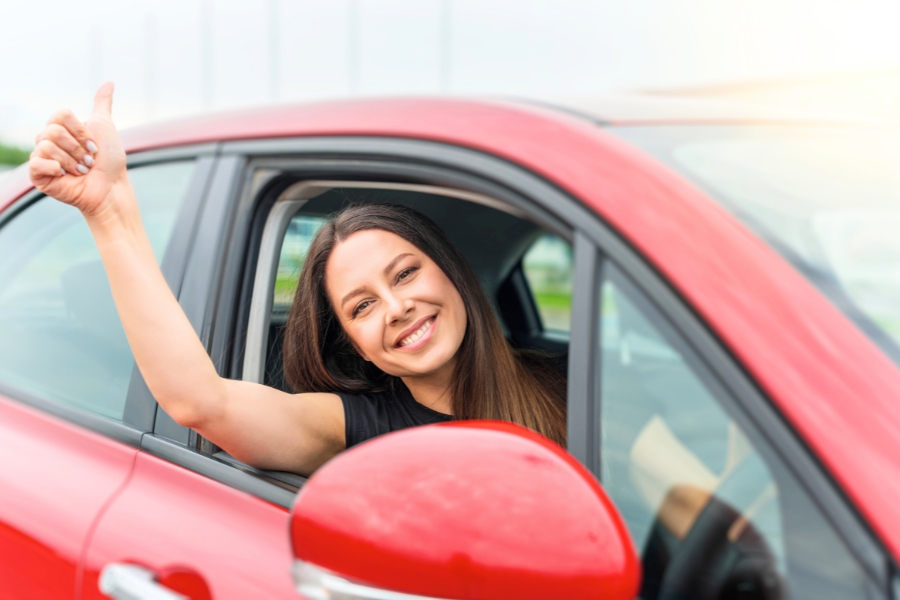 Woman Driving a Red Car