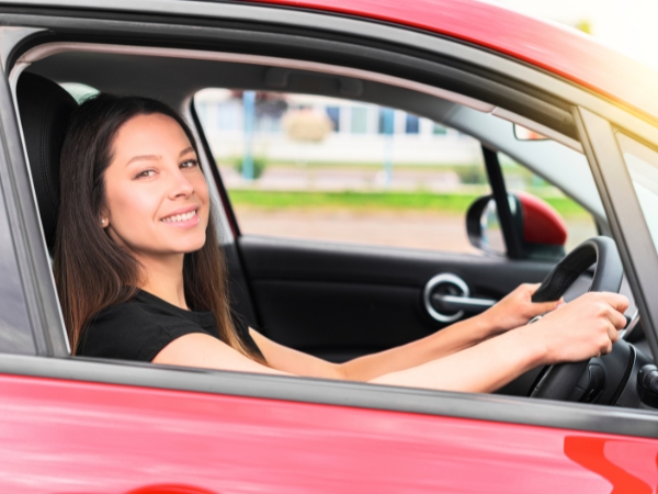 Woman Driving a Red Car