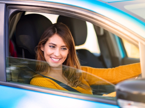 Woman Driving a Blue Car