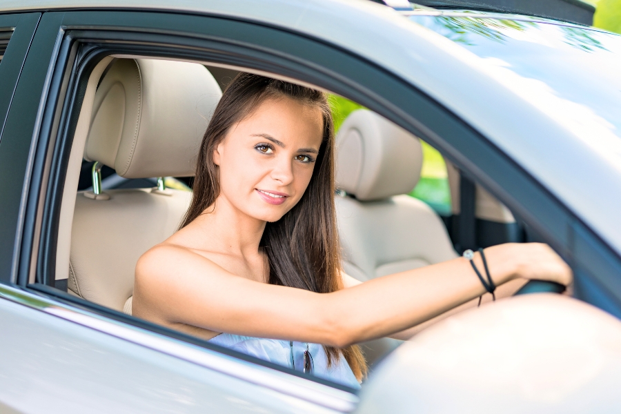 Woman Driving a Silver Car